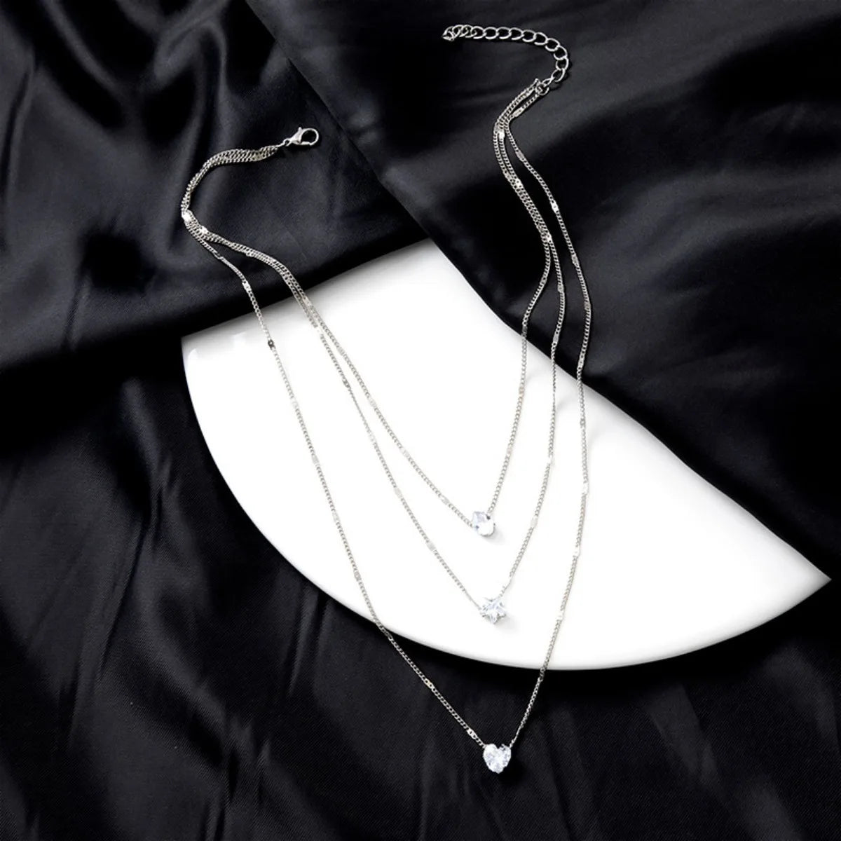 Chic layered necklace – star, heart, and drop details in harmony.