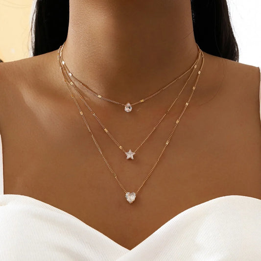 Chic layered necklace – star, heart, and drop details in harmony.