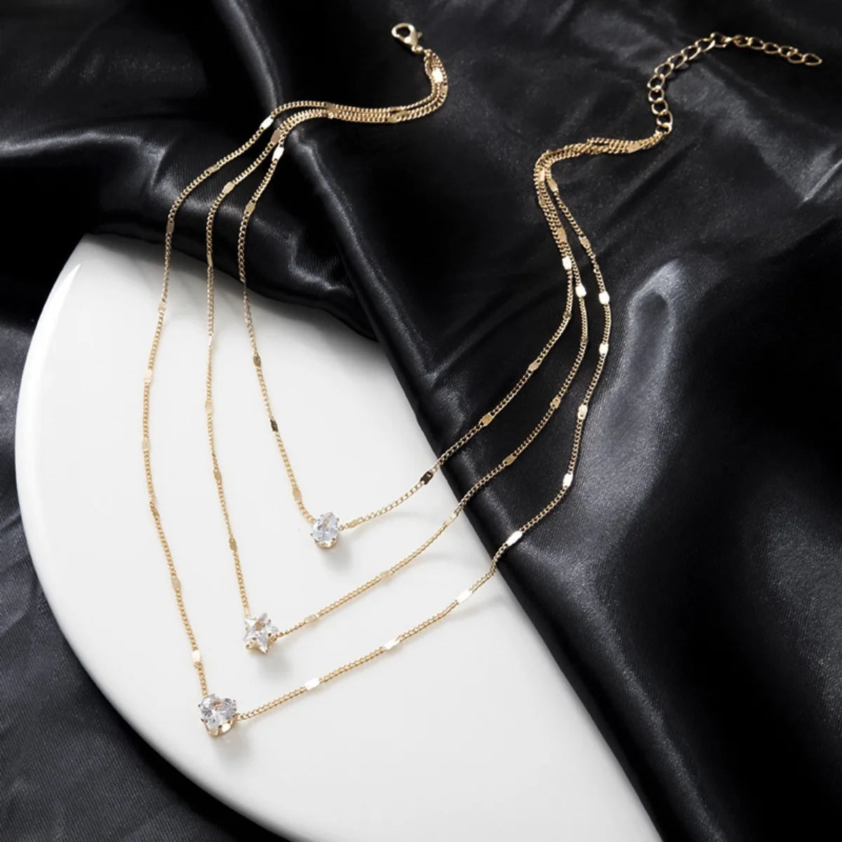 Chic layered necklace – star, heart, and drop details in harmony.